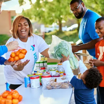 People handing food out to a family