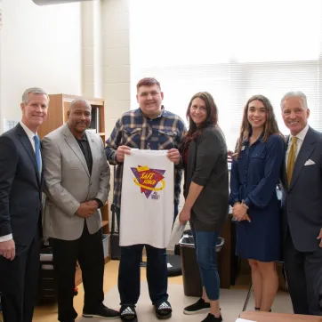 Teenager holding up a tshirt