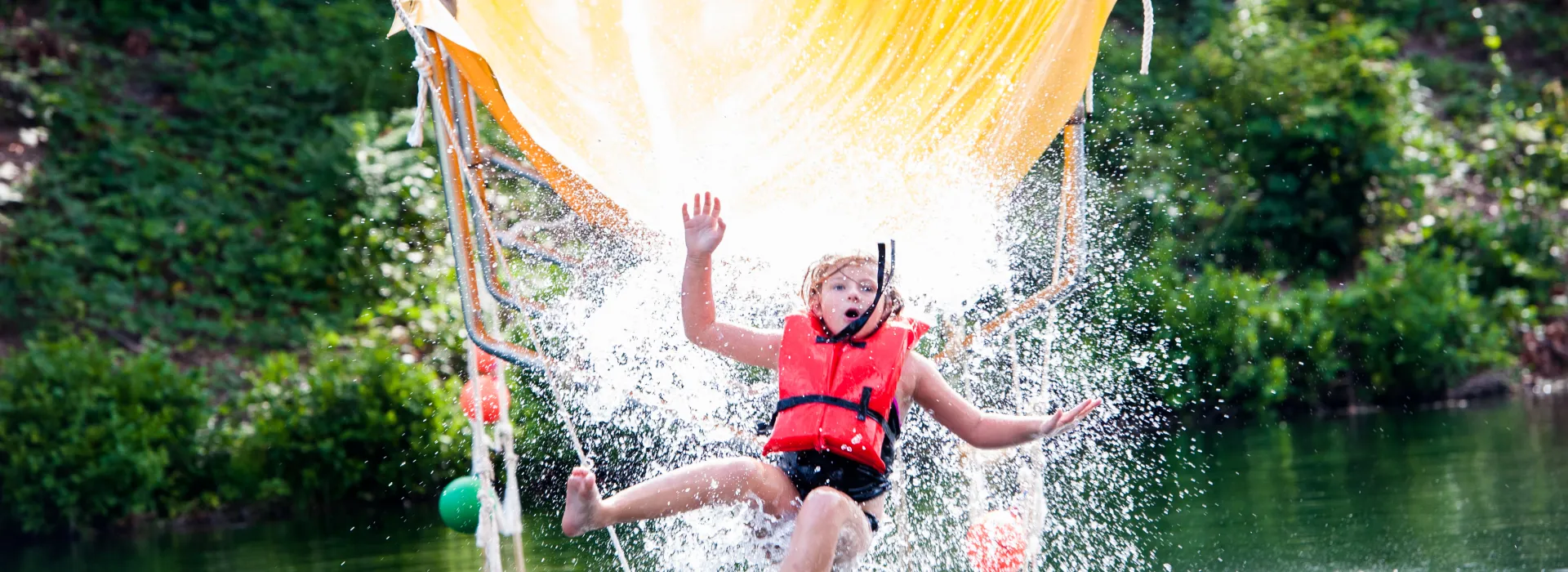 Child on Camp Hanes water zip line