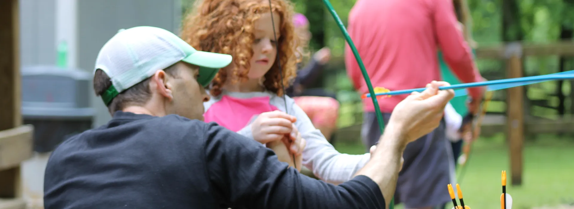 Dad and daughter doing archery